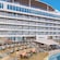 Artist rendering of Wayfinder Bay on the deck of the Disney Adventure, featuring a large pool surrounded by lounge chairs and dining areas